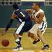 Eastern Washtenaw Multicultural sophomore Kornelius Saxton moves the ball around Greenhills junior Andikan Archibong during the second half at Greenhills on Thursday. Melanie Maxwell I AnnArbor.com